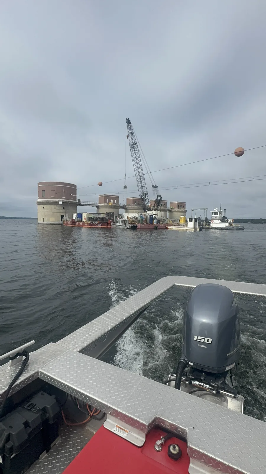 An ECHERER crew rides a workboat across the lake toward the intake towers job site